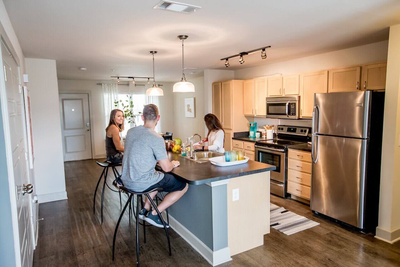 Wildwood Baton Rouge LSU Off-Campus Apartments Kitchen with Students sitting at table